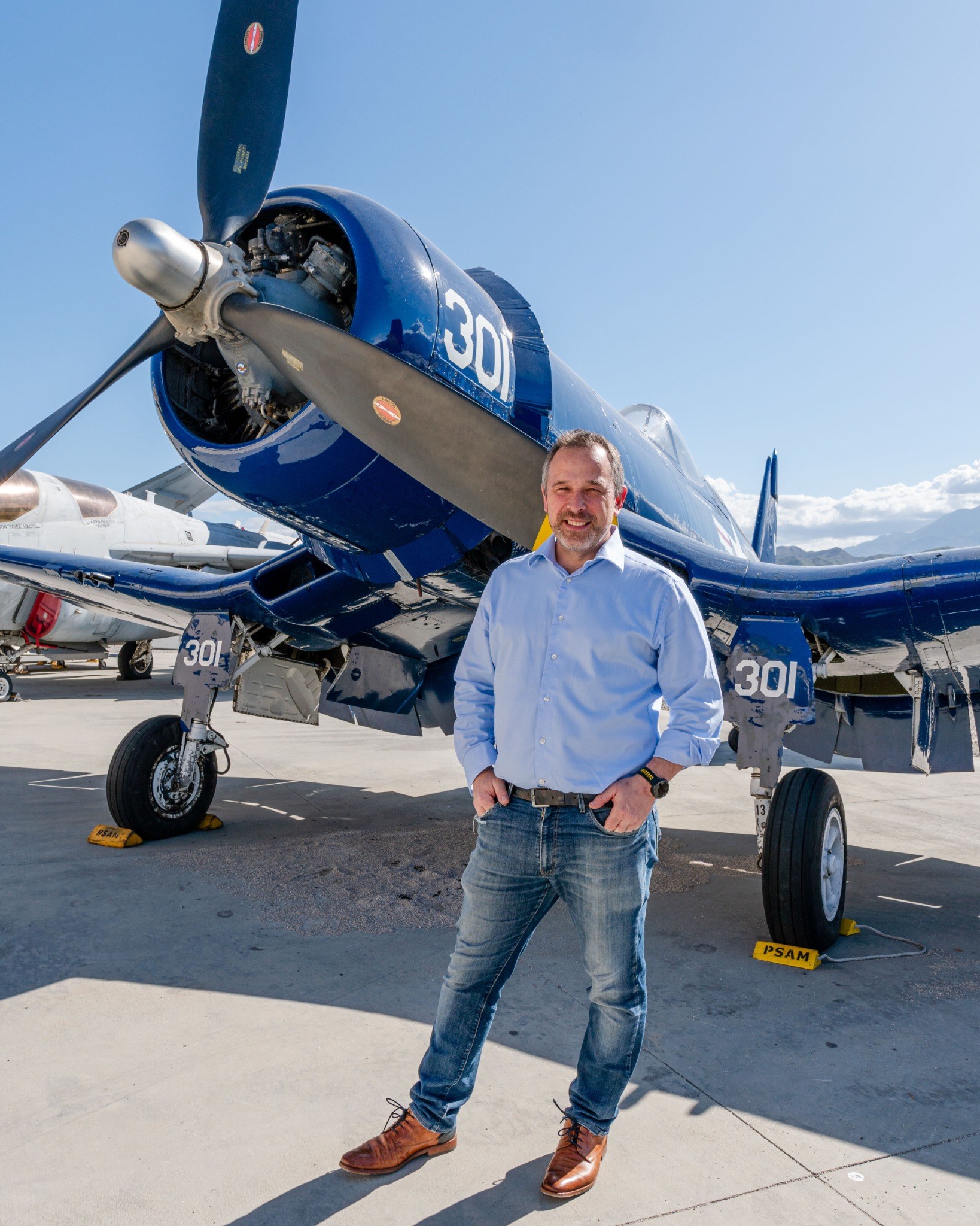 Tom Verbruggen beside a vintage aircraft